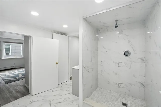 a bathroom with a shower and a sink