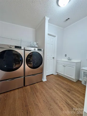a bathroom with a sink and a washer dryer