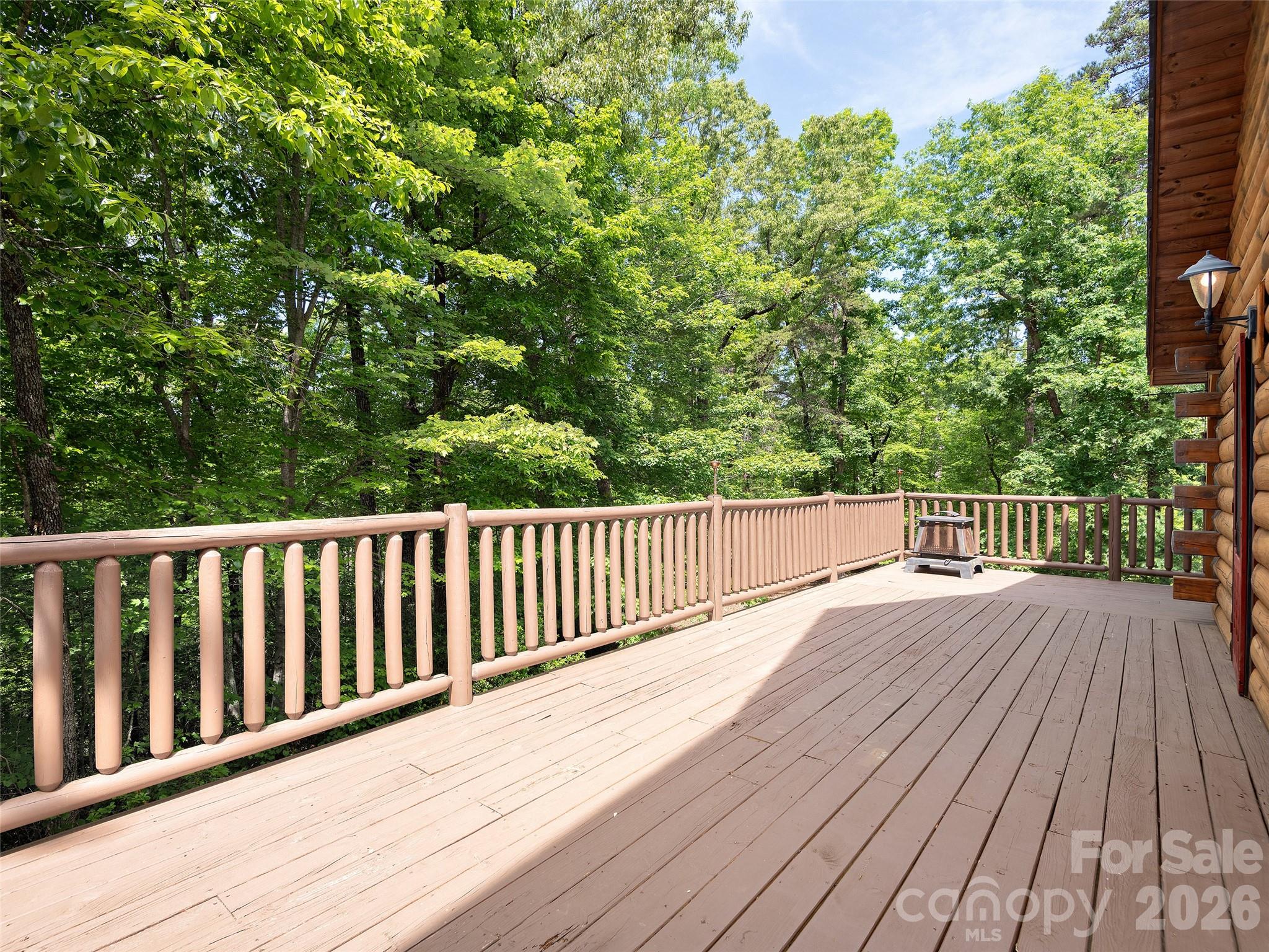 413 Green Hills Road Mill Spring, NC 28756 - Photo 41 of 48 a view of wooden deck and a garden