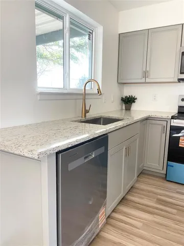 a kitchen with a sink and a stove top oven