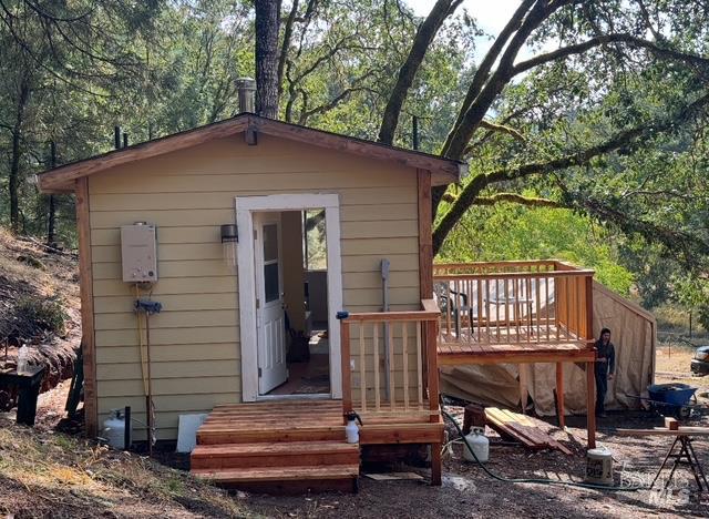 6651 Hearst Willits Road Willits, CA 95490 - Photo 3 of 11 a backyard of a house with barbeque oven and outdoor seating