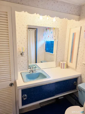 an empty room with wooden floor and closet