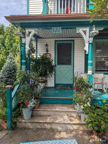 a view of a room with furniture and wooden floor