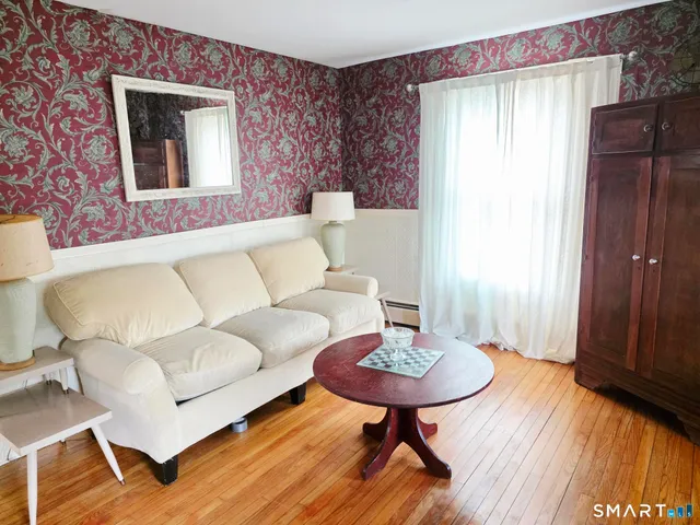 a room with a stove and a wooden floor