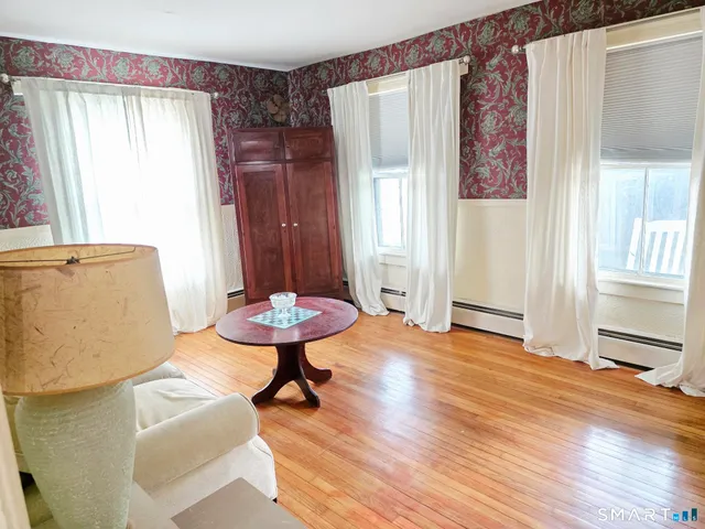 a kitchen that has a stove and a table chair