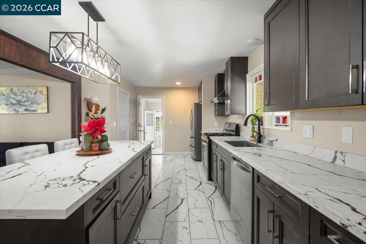 24685 Fuhrman Road Acampo, CA 95220 - Photo 21 of 58 a kitchen with a sink dishwasher and a stove with wooden floor