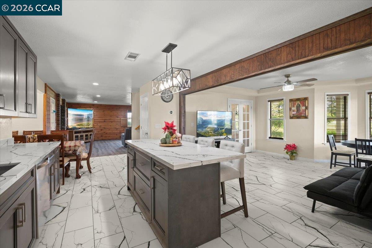 24685 Fuhrman Road Acampo, CA 95220 - Photo 22 of 58 a living room with granite countertop furniture a chandelier and kitchen view