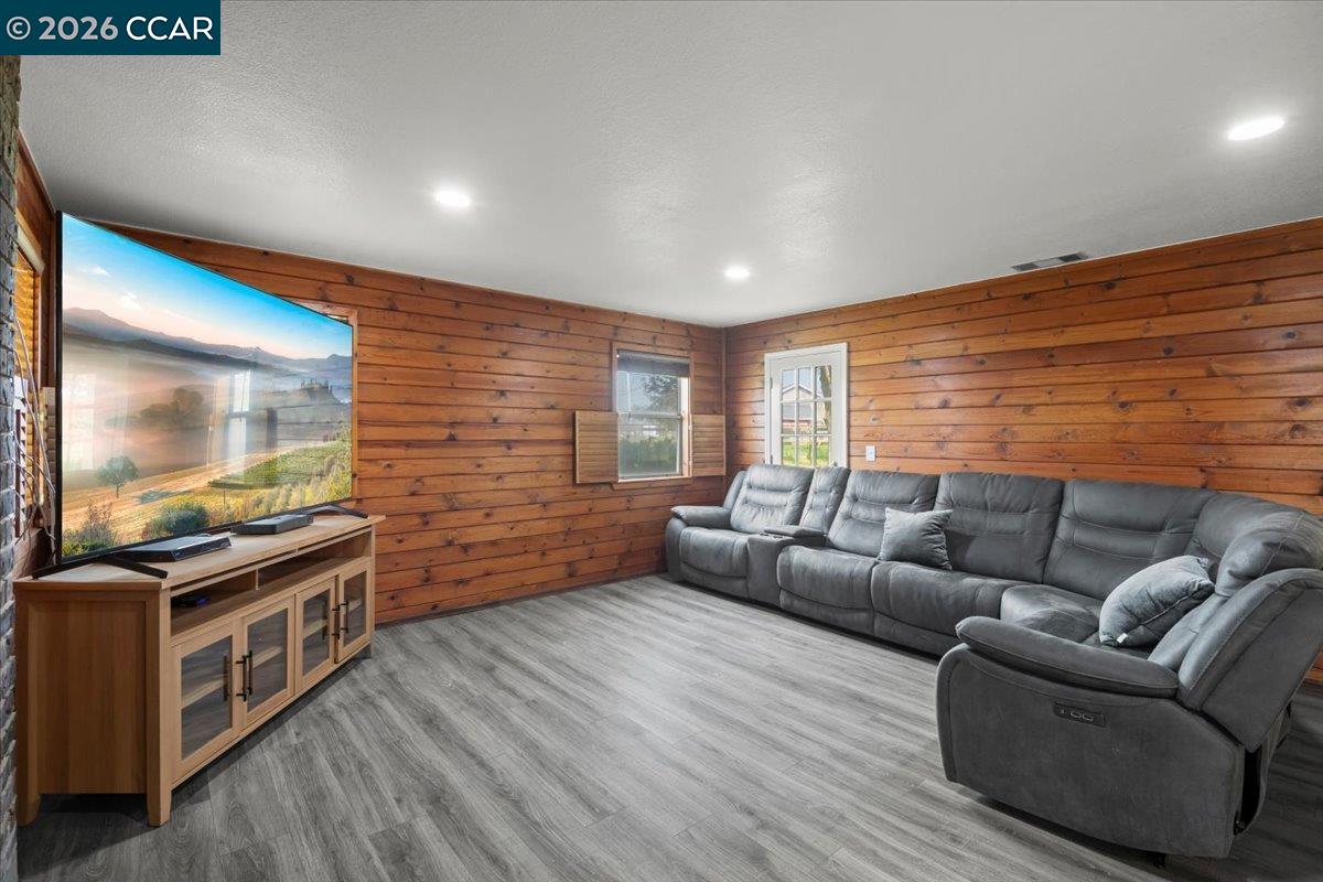 24685 Fuhrman Road Acampo, CA 95220 - Photo 24 of 58 a living room with furniture a flat screen tv and kitchen view