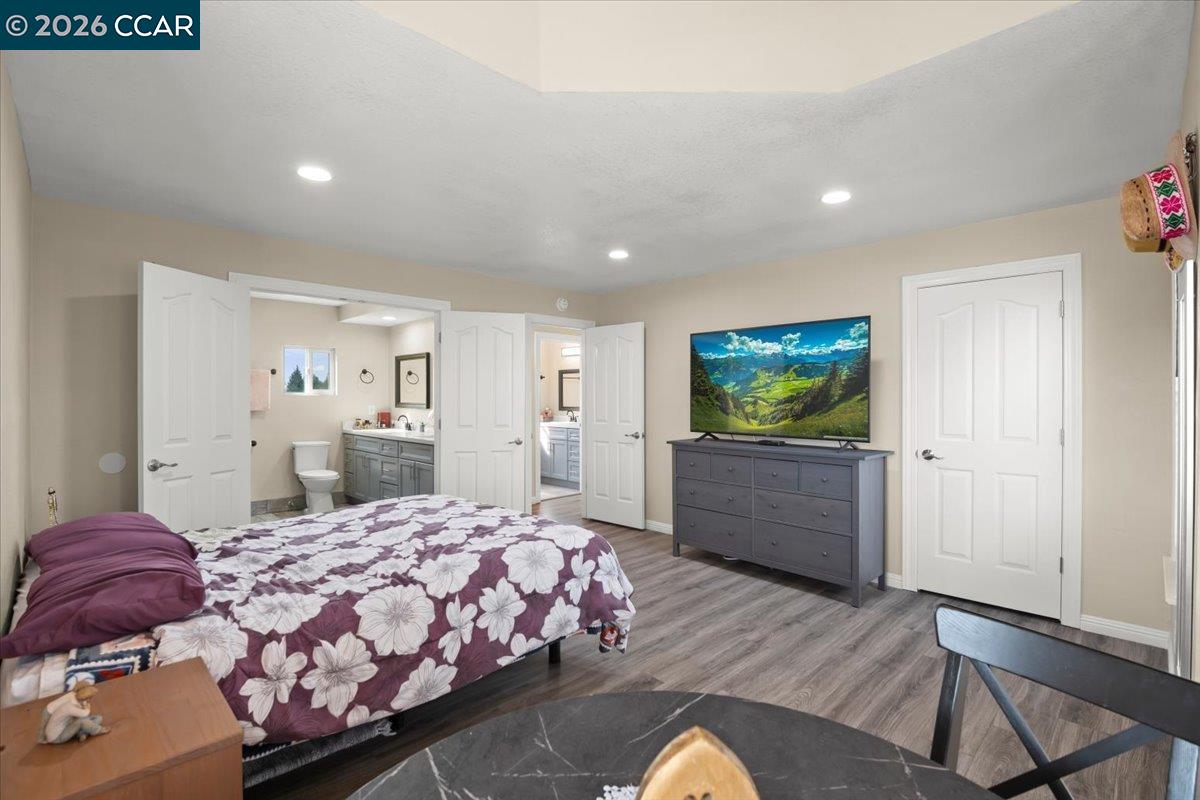 24685 Fuhrman Road Acampo, CA 95220 - Photo 28 of 58 a bedroom with a bed and a flat screen tv