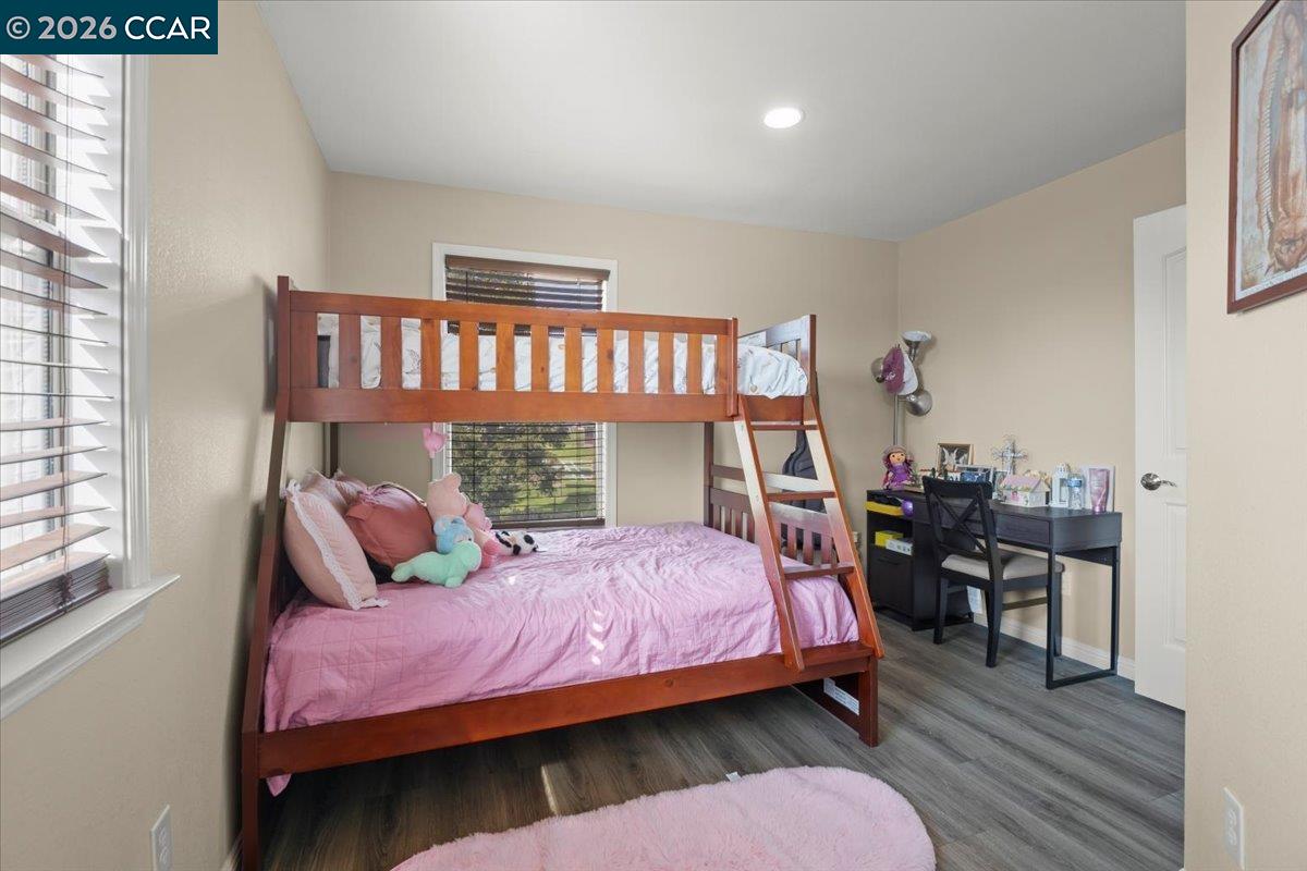 24685 Fuhrman Road Acampo, CA 95220 - Photo 31 of 58 a bedroom with a bed and wooden floor