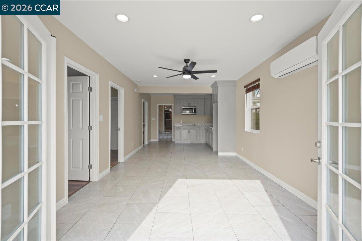 24685 Fuhrman Road Acampo, CA 95220 - Photo 36 of 58 a view of a hallway with a chandelier fan and windows