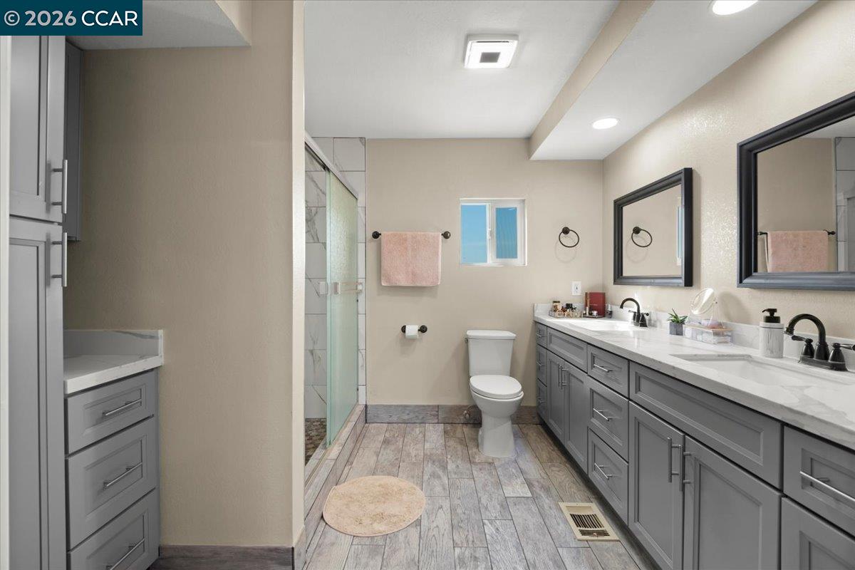 24685 Fuhrman Road Acampo, CA 95220 - Photo 6 of 58 a bathroom with a granite countertop sink mirror vanity and toilet