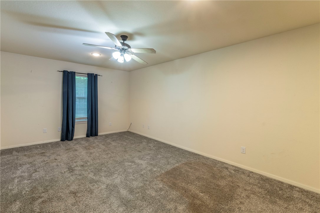 1203 Ave B Waco, TX 76705 - Photo 13 of 32 an empty room with a fan & a ceiling fan