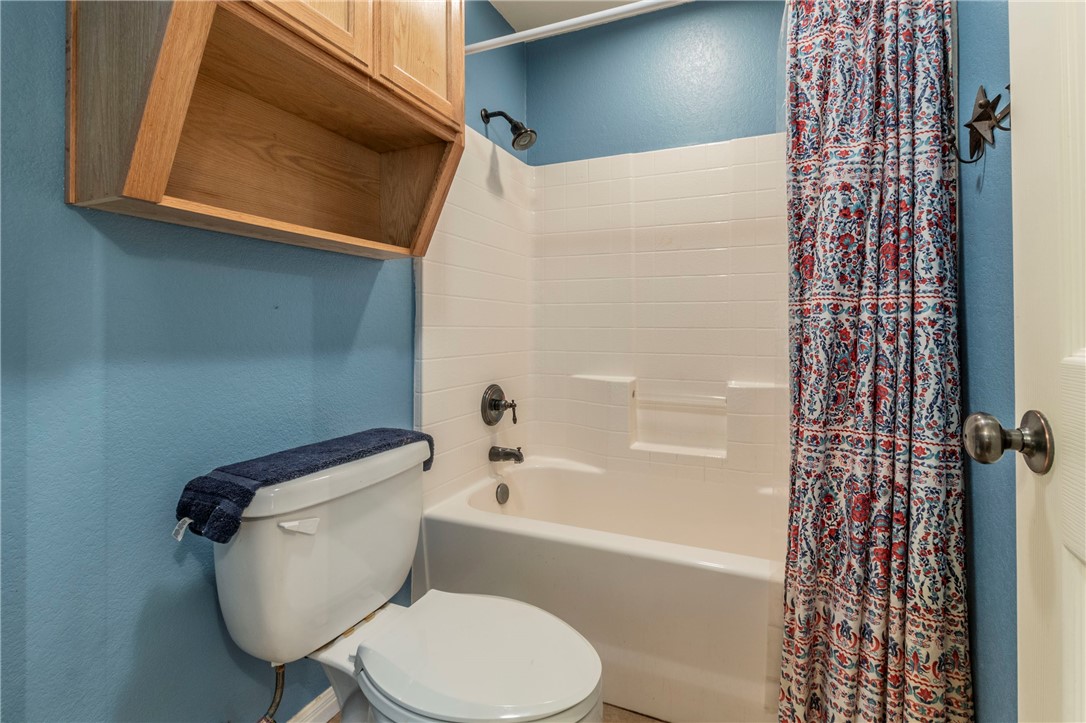 1203 Ave B Waco, TX 76705 - Photo 19 of 32 a white toilet sitting next to a bath tub