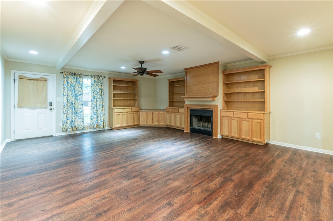 1203 Ave B Waco, TX 76705 - Photo 2 of 32 an empty room with wooden floor closet and windows