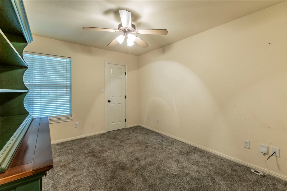 1203 Ave B Waco, TX 76705 - Photo 22 of 32 an empty room with a chandelier fan