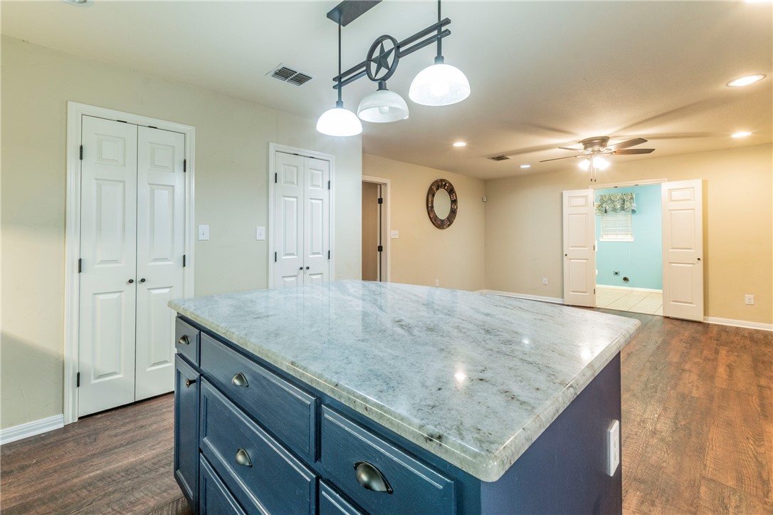 1203 Ave B Waco, TX 76705 - Photo 8 of 32 a view of a kitchen island a sink and dishwasher
