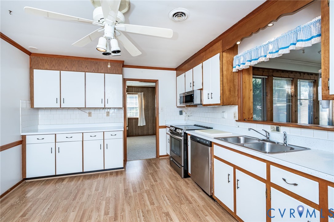 12310 Harrowgate Road Chester, VA 23831 - Photo 10 of 27 a kitchen with stainless steel appliances granite countertop hardwood floor sink stove and granite counter top