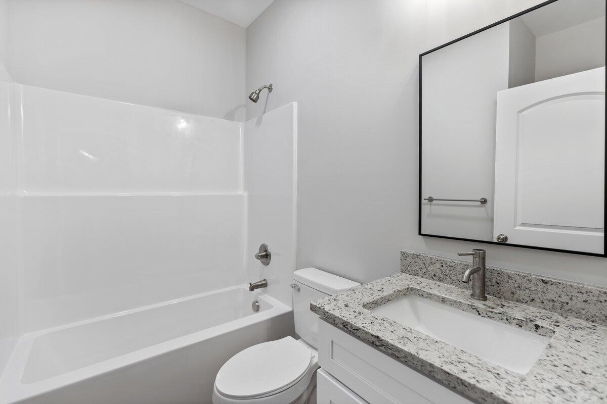 129 County Road 155 Riceville, TN 37370 - Photo 16 of 31 a bathroom with a granite countertop sink toilet and shower