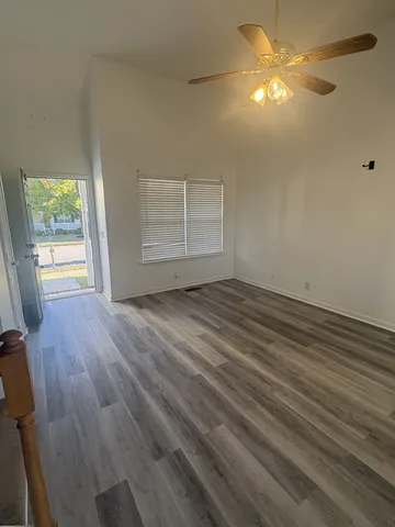wooden floor in an empty room with a window