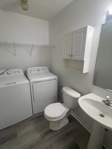 a white toilet sitting next to a bathroom sink