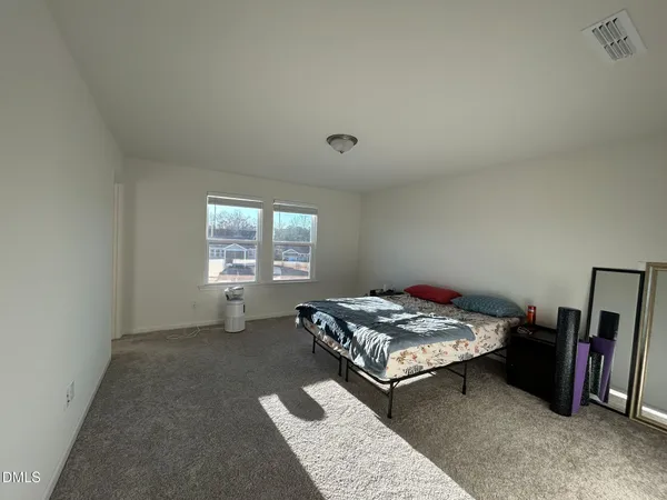 a bedroom with bed and a window