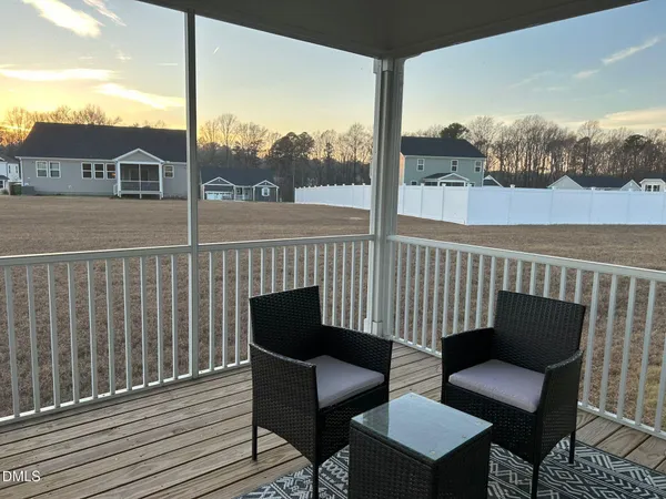 a view of a chair and table on the deck