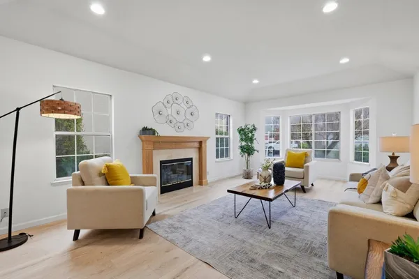 a living room with furniture and a fireplace