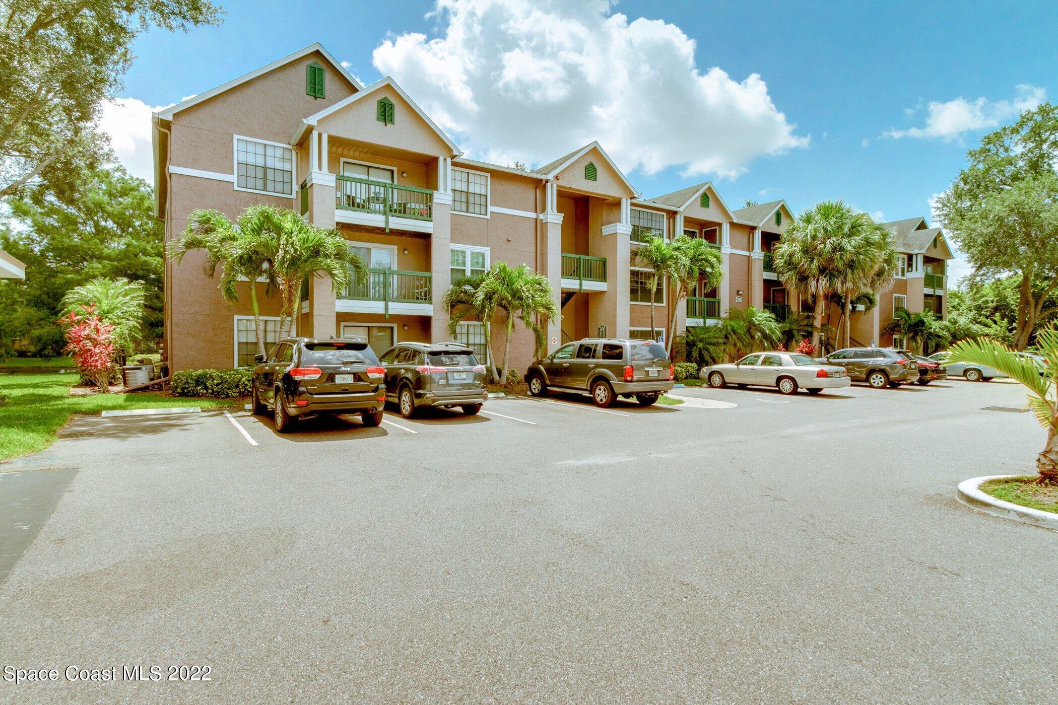 7667 North Wickham Road, Unit 703 Melbourne, FL 32940 - Photo 1 of 40 a view of a city street and car parked