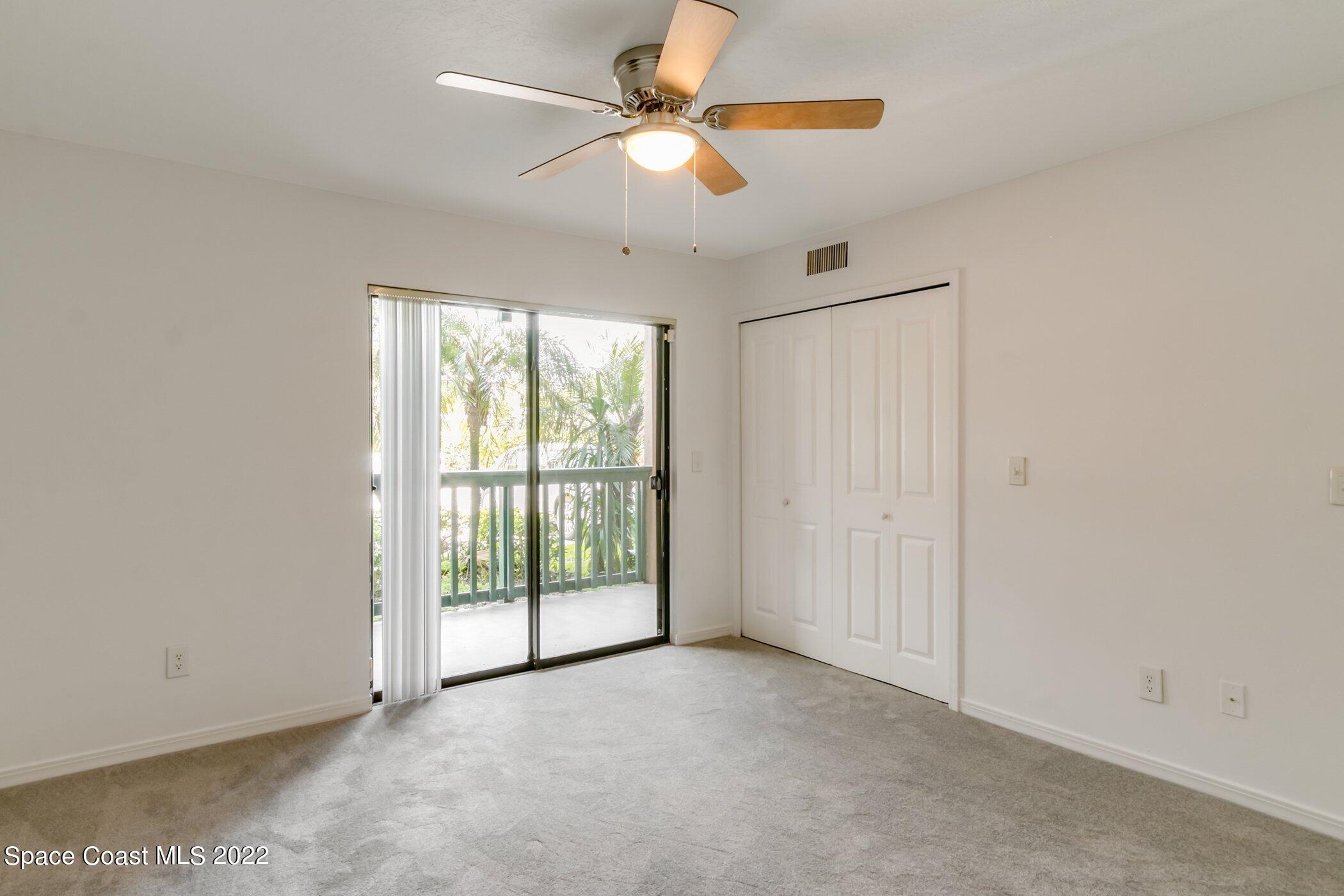 7667 North Wickham Road, Unit 703 Melbourne, FL 32940 - Photo 21 of 40 an empty room with chandelier fan