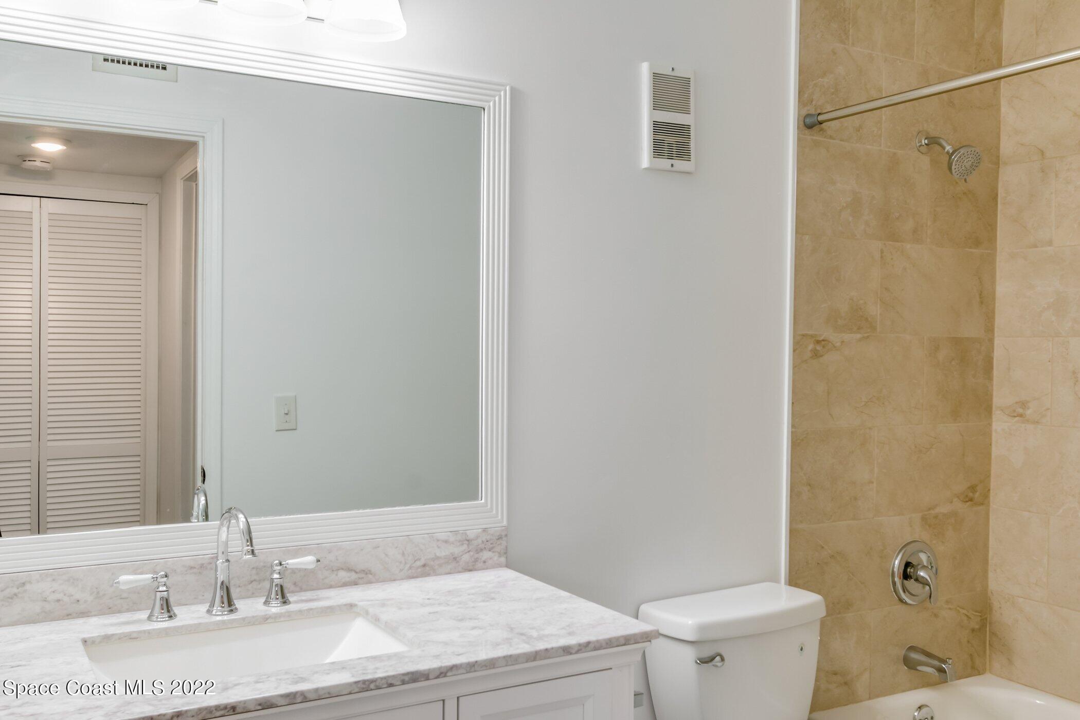 7667 North Wickham Road, Unit 703 Melbourne, FL 32940 - Photo 24 of 40 a bathroom with a granite countertop sink toilet and shower