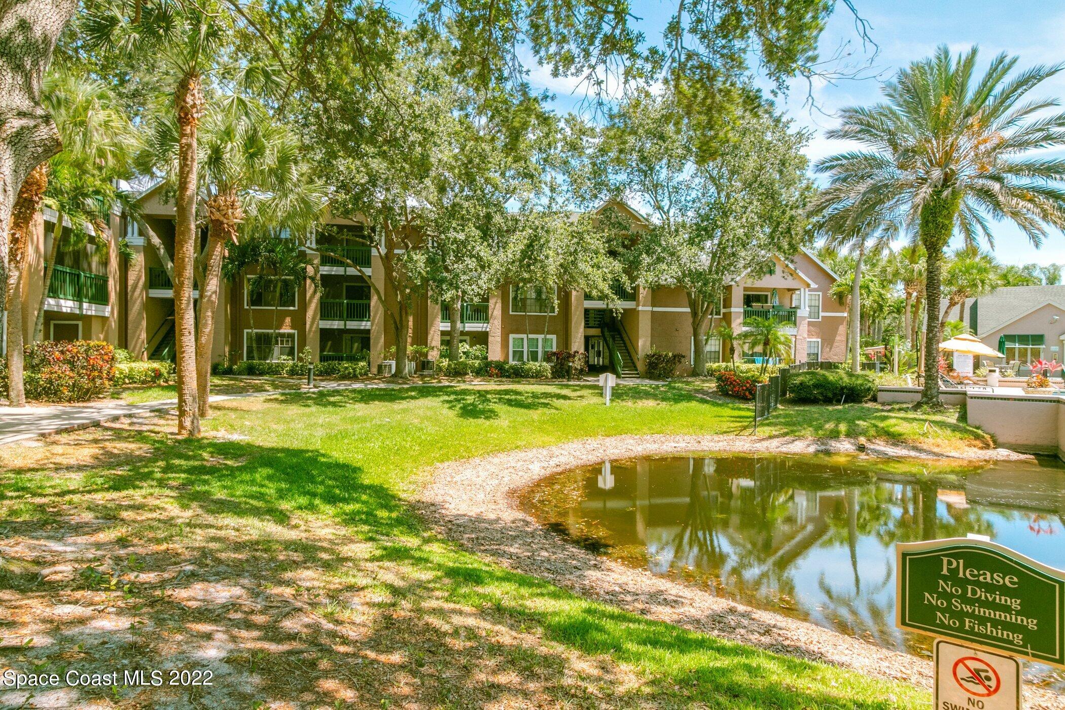 7667 North Wickham Road, Unit 703 Melbourne, FL 32940 - Photo 35 of 40 a swimming pool with outdoor seating and yard