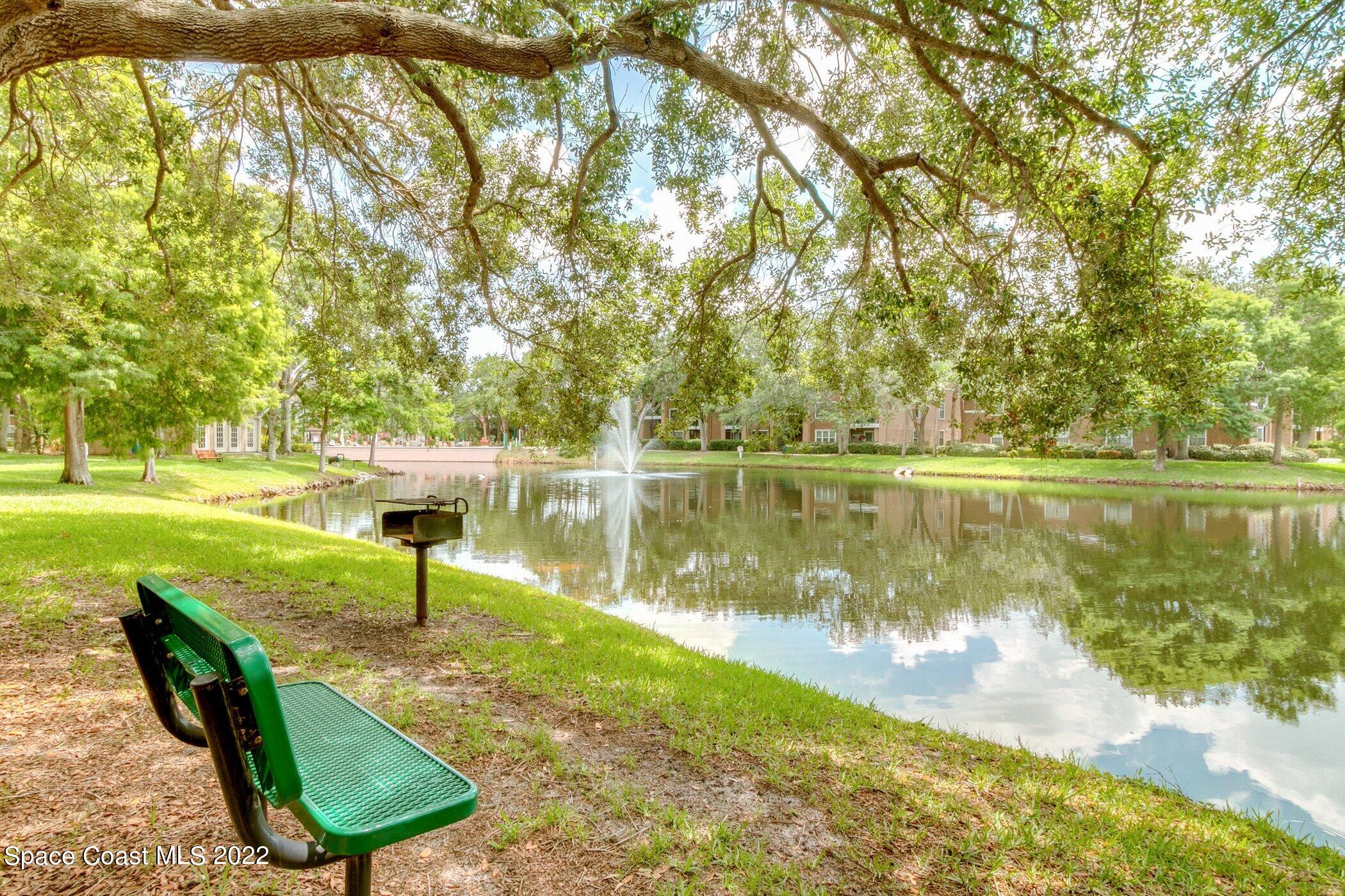 7667 North Wickham Road, Unit 703 Melbourne, FL 32940 - Photo 40 of 40 a view of a lake with a yard and potted plants