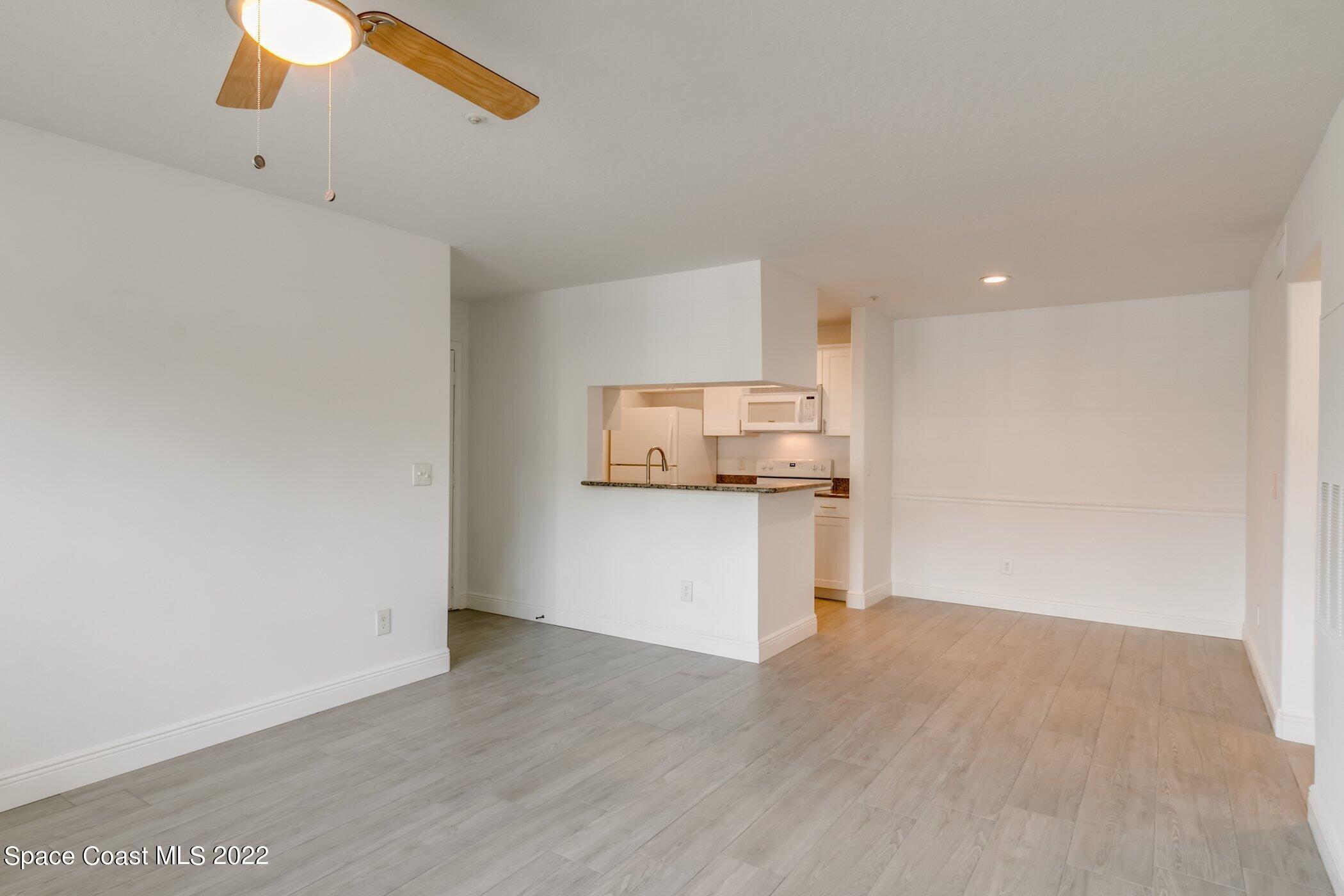 7667 North Wickham Road, Unit 703 Melbourne, FL 32940 - Photo 6 of 40 a view of kitchen and wooden floor