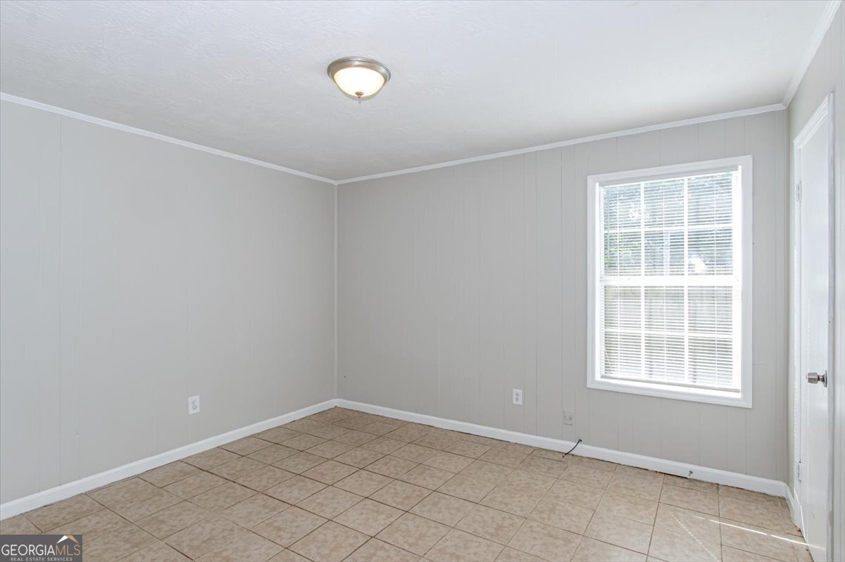 1232 12th Street, Unit D Augusta, GA 30901 - Photo 11 of 27 an empty room with windows