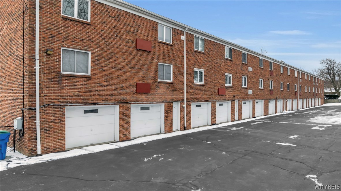 335 South Cayuga Road, Unit B Amherst, NY 14221 - Photo 25 of 30 Back of building with garages (4th garage door in)