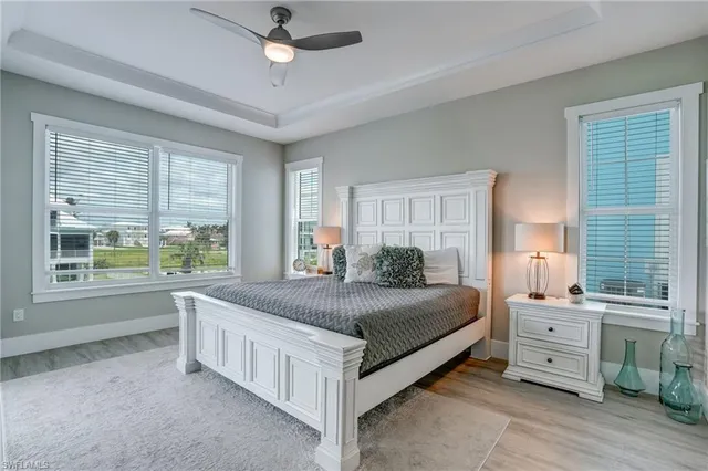 a bedroom with a large bed and a chandelier