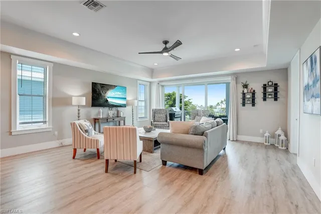 a living room with furniture and a view of kitchen