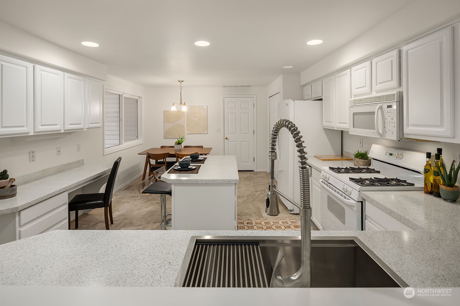 4801 Northeast 18th Place, Unit B Renton, WA 98059 - Photo 11 of 36 a open kitchen with stainless steel appliances granite countertop a stove top oven a sink dishwasher and white cabinets with wooden floor