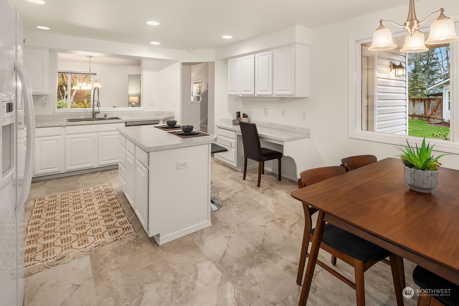 4801 Northeast 18th Place, Unit B Renton, WA 98059 - Photo 14 of 36 a kitchen with a table and chairs in it