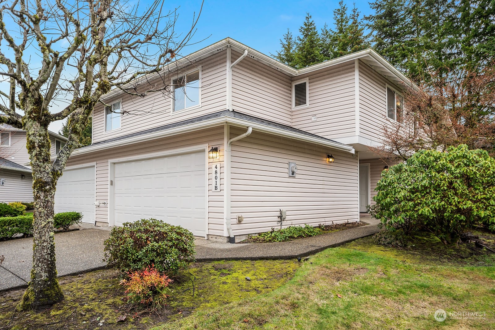 4801 Northeast 18th Place, Unit B Renton, WA 98059 - Photo 2 of 36 a view of a house with a yard and a garden