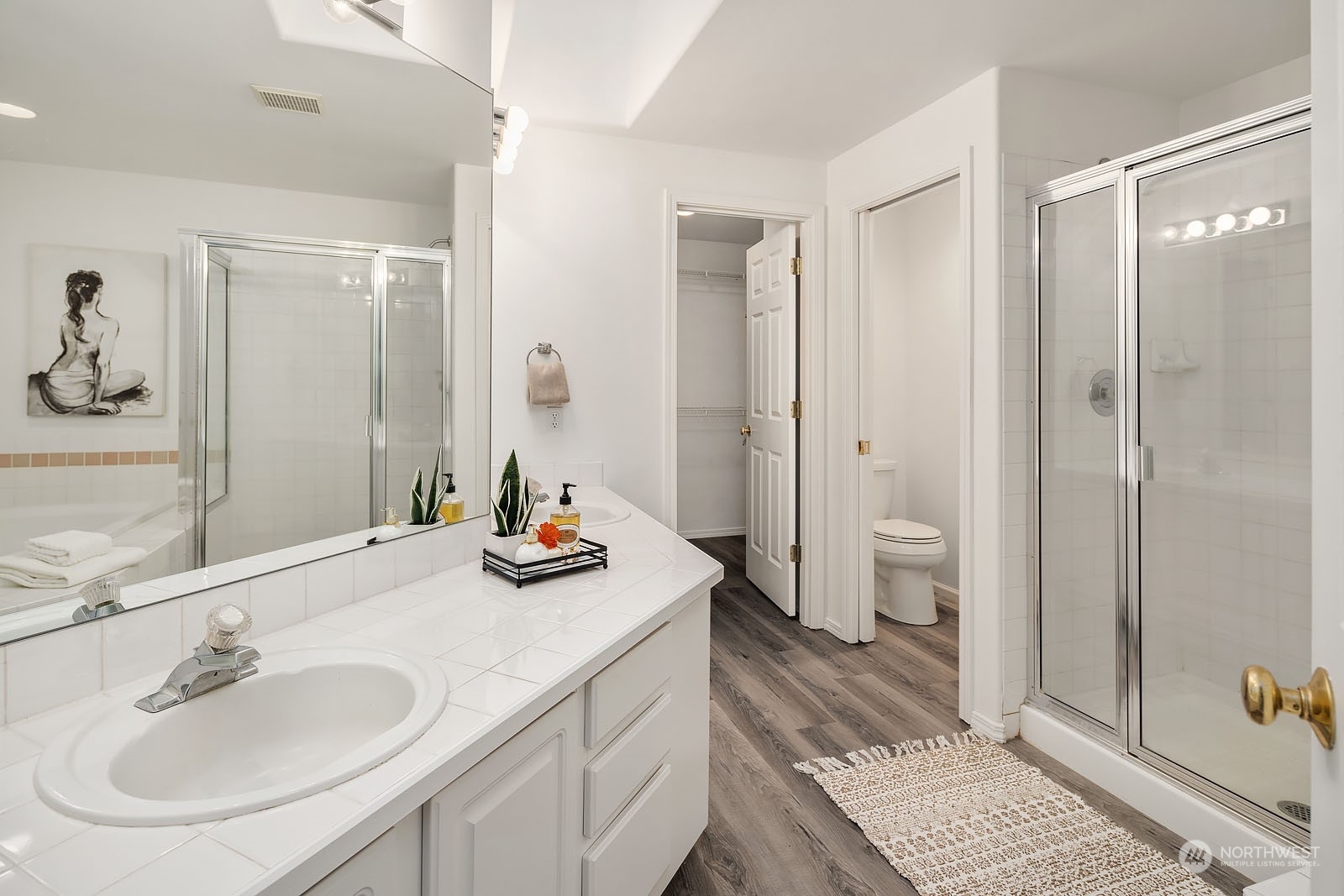 4801 Northeast 18th Place, Unit B Renton, WA 98059 - Photo 22 of 36 a bathroom with a sink a toilet and shower