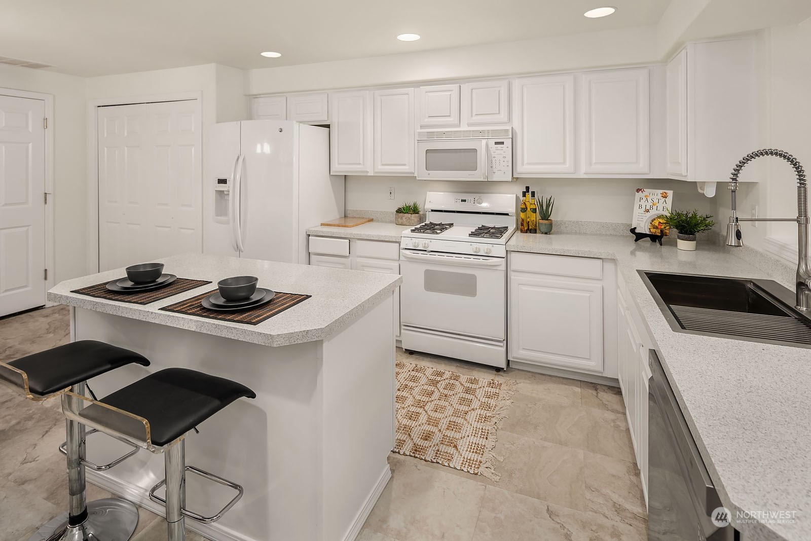 4801 Northeast 18th Place, Unit B Renton, WA 98059 - Photo 10 of 36 a kitchen with a stove cabinets a sink and a refrigerator
