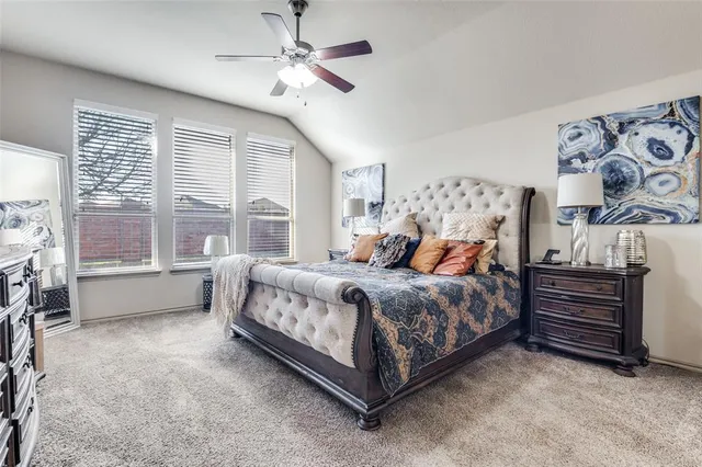 a spacious bedroom with a bed and a window