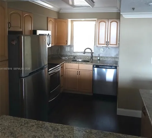 a kitchen with a refrigerator and a sink