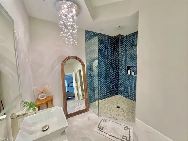 a bathroom with a bathtub sink and mirror
