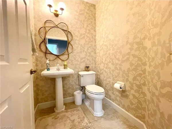 a bathroom with a sink toilet and mirror