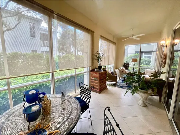 a living room with furniture and floor to ceiling windows