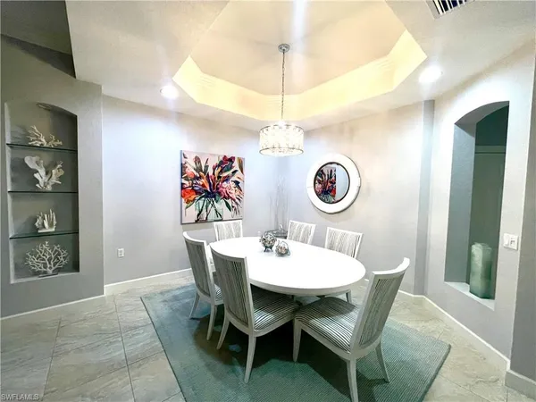 a dining room with a wooden table and chairs