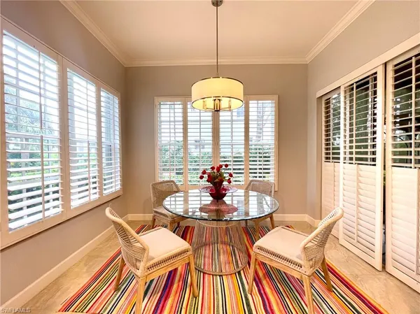 a dining room with furniture a chandelier and wooden floor